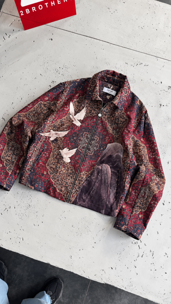 A zip-up jacket in a vintage paisley and rug-inspired pattern