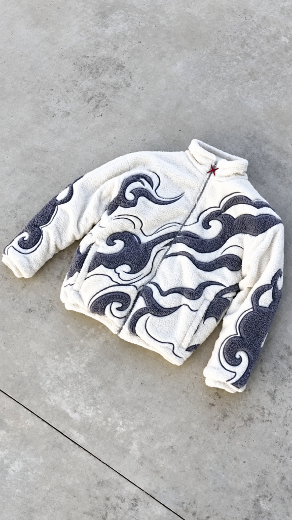 A printed sherpa fleece jacket with a playful streetwear graphic