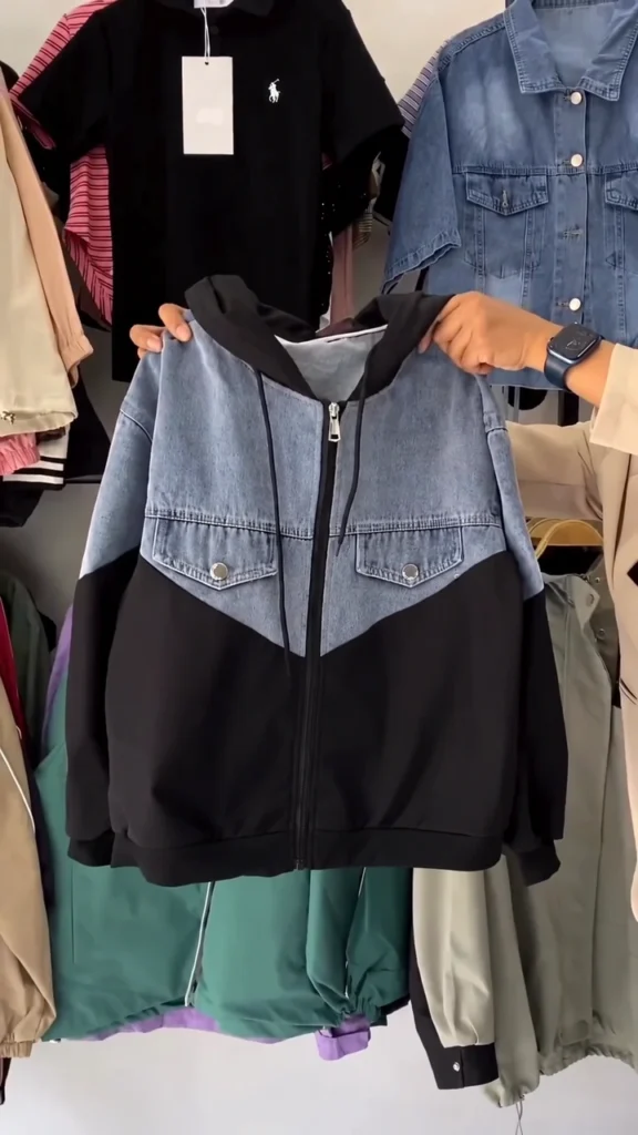 A black hooded jacket-style top in a regular fit