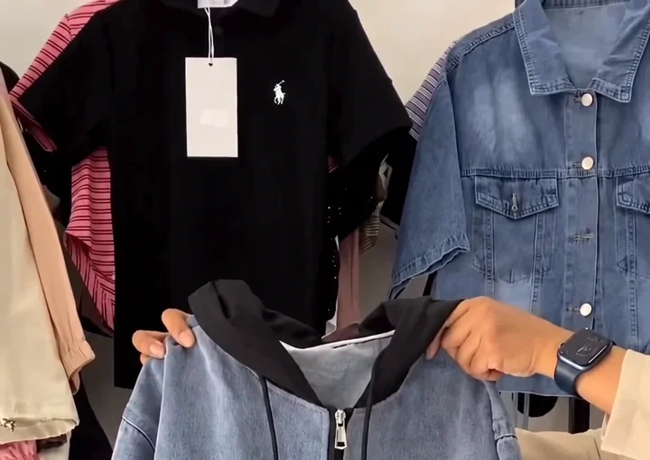 A black hooded jacket-style top in a regular fit