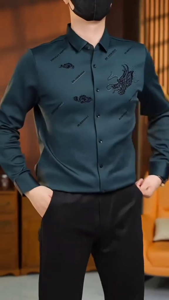 A teal green designer shirt with artistic embroidery